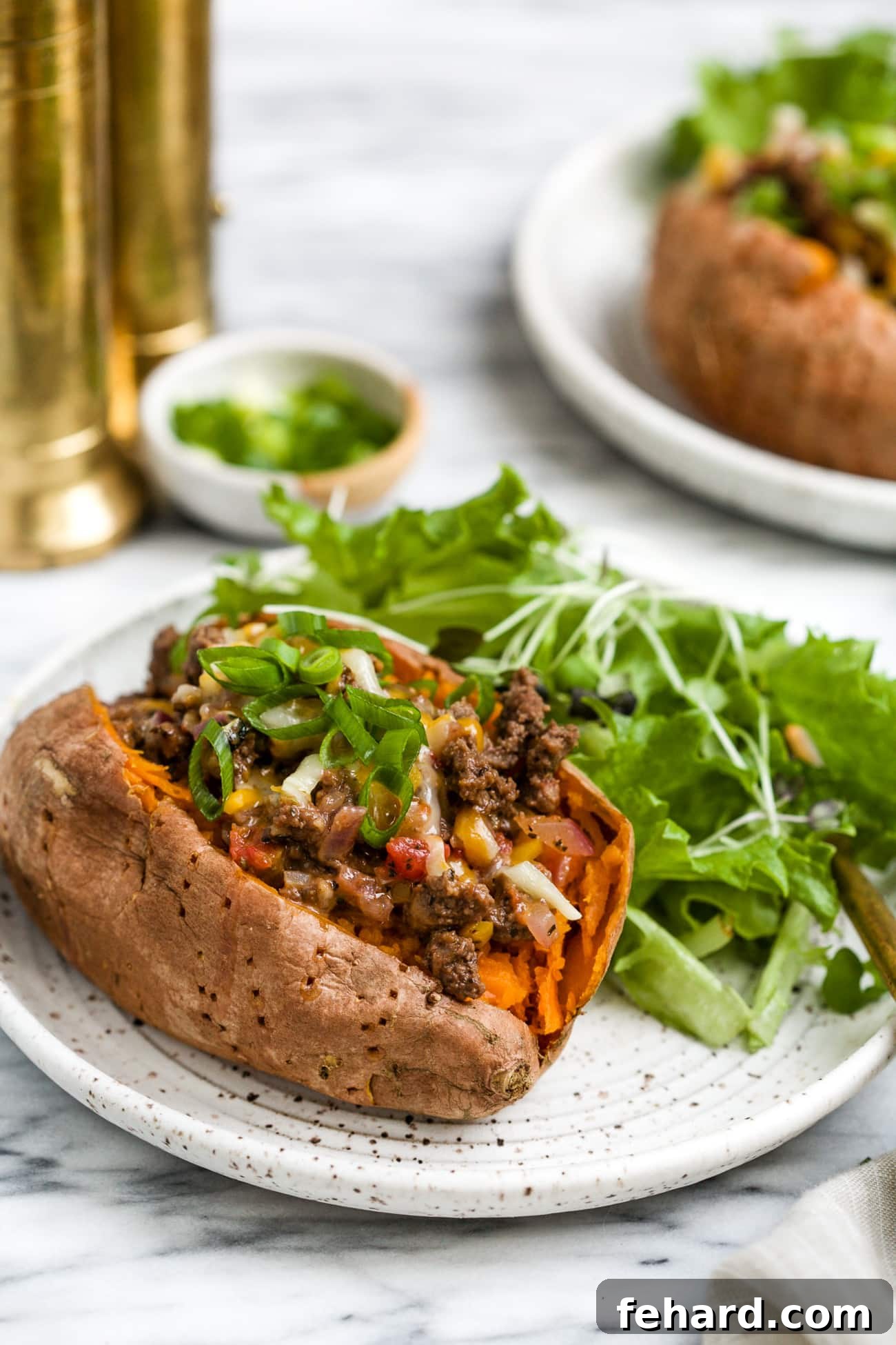 closeup view of stuffed sweet potato on a white plate.