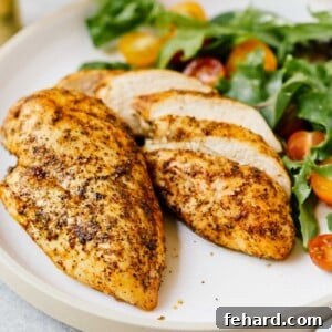 closeup of 2 air fryer chicken breast on a white plate