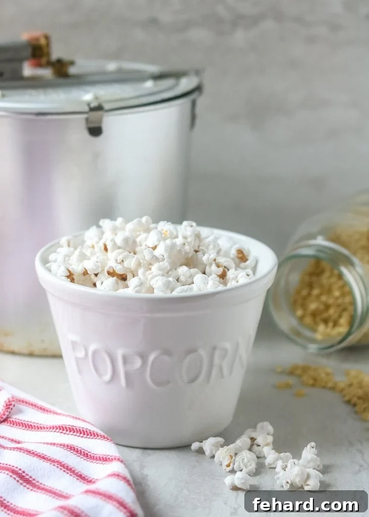 Stovetop Popcorn Easy Homemade Popcorn in a white popcorn bowl, ready to be enjoyed.