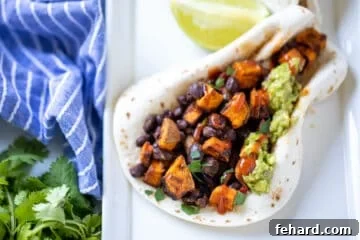 flour tortilla filled with sweet potatoes, black beans, and guacamole.