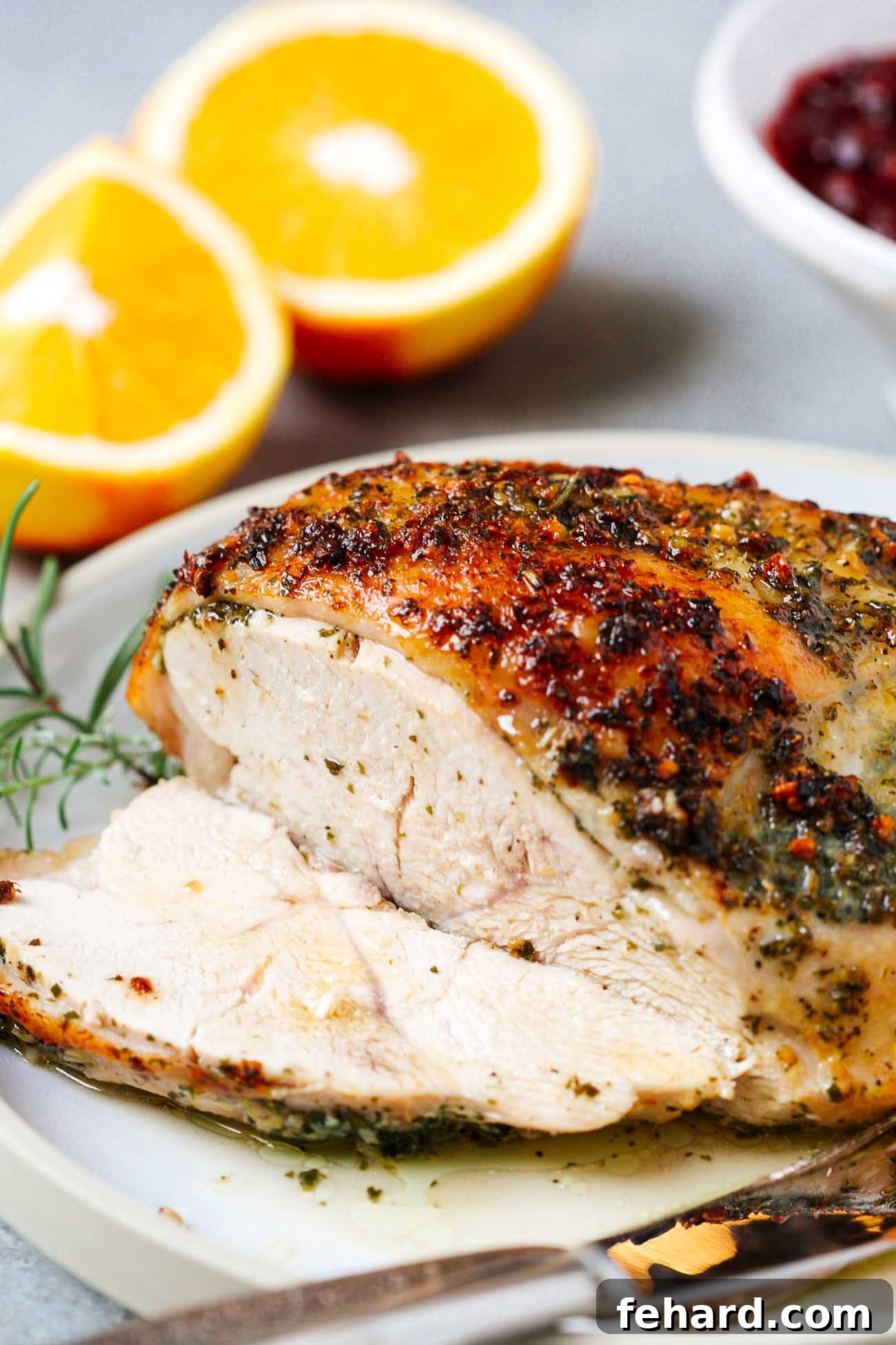 A beautifully roasted garlic butter turkey breast, expertly carved to reveal its tender, juicy interior.