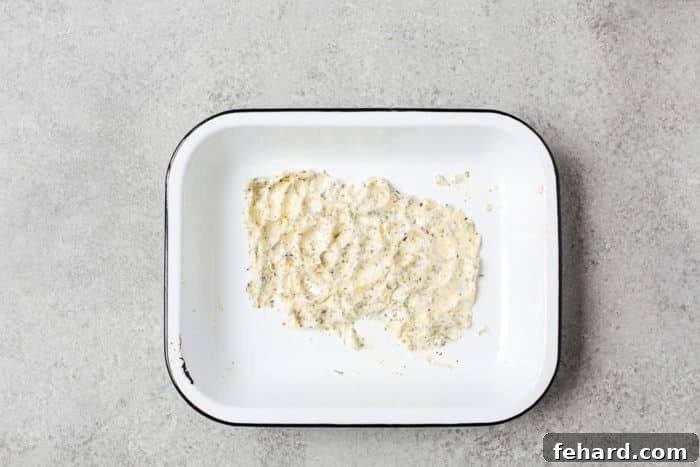 Any leftover garlic butter mixture melted in the bottom of a baking pan, ready to infuse flavor into the turkey.