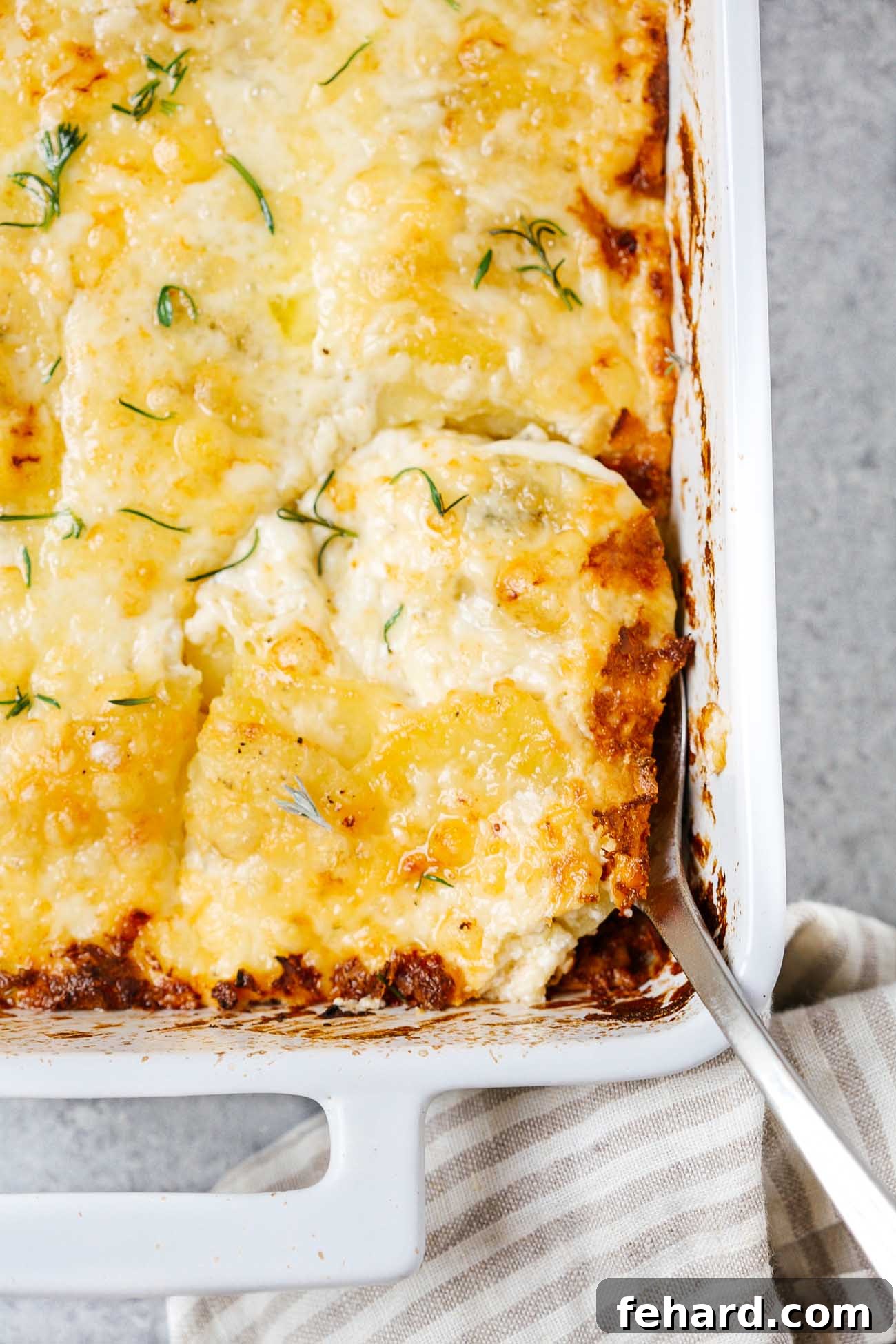 Golden Baked Cheesy Potatoes 10 closeup of potatoes au gratin in a casserole