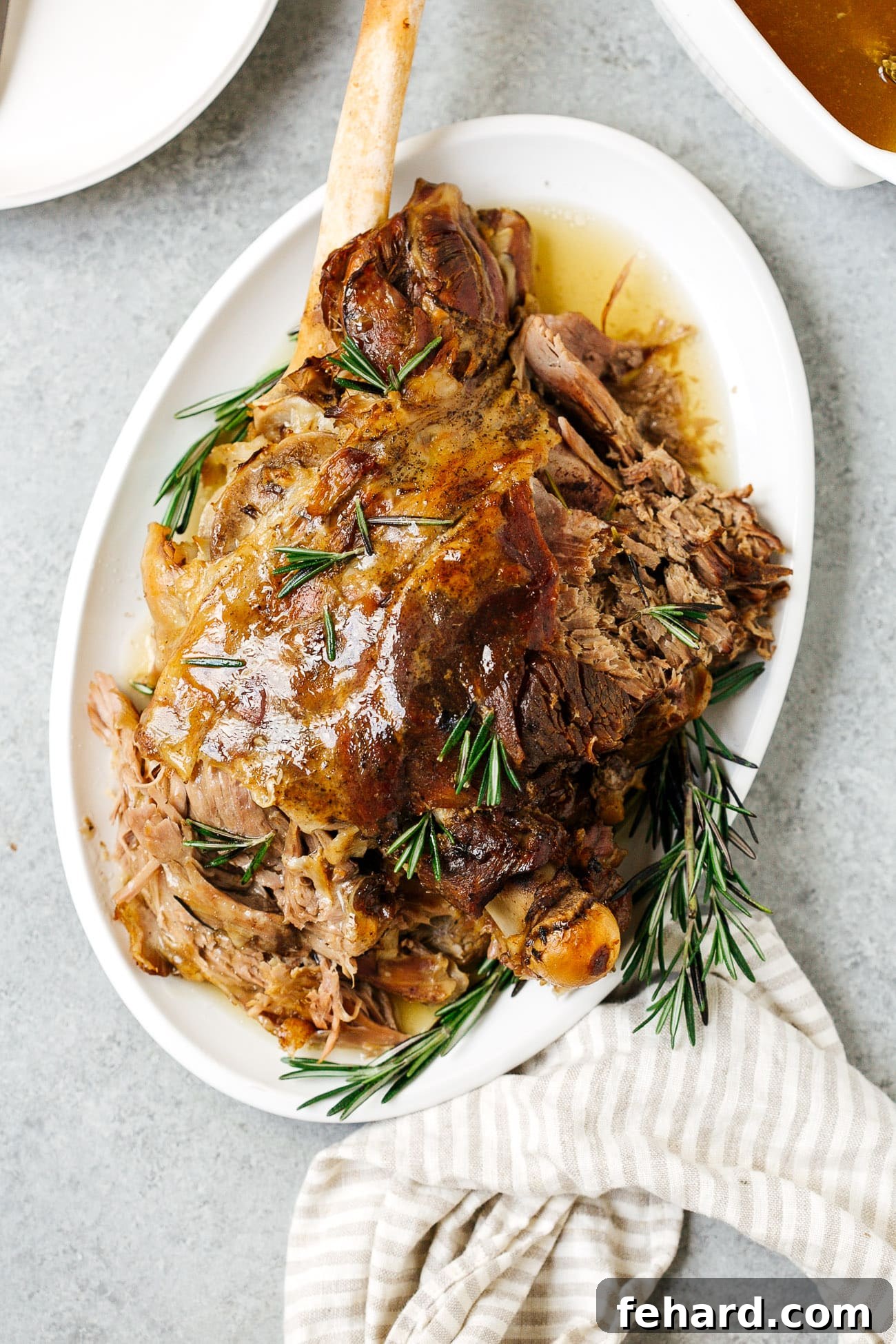Fall-Off-The-Bone Slow Roast Lamb 4 Overhead view of slow roast leg of lamb served on a platter.