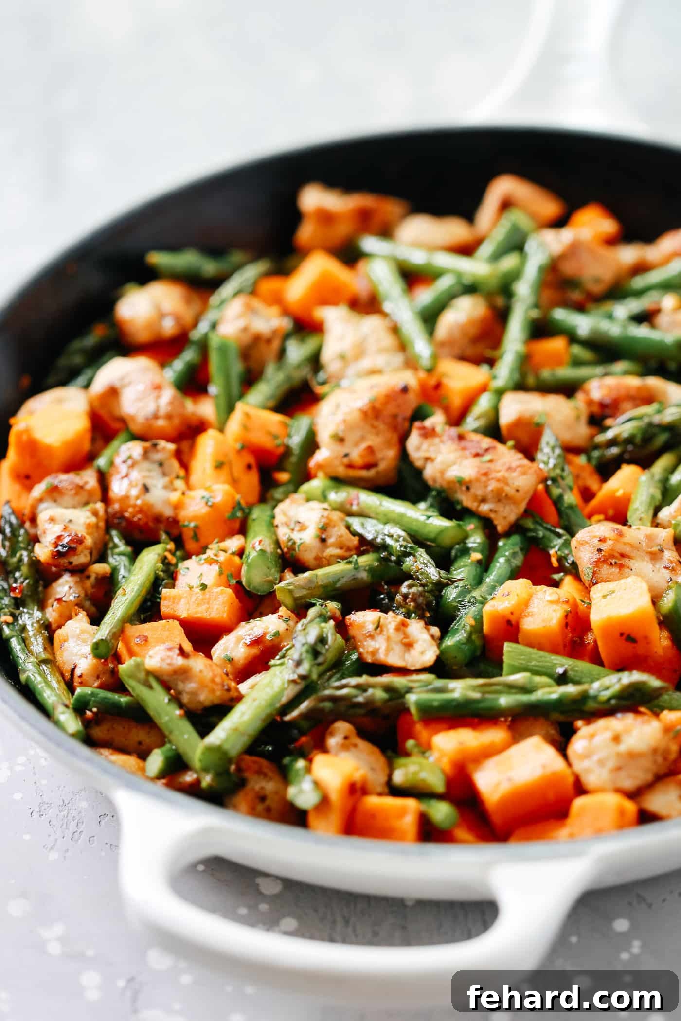 An inviting overhead view of the complete one-pan chicken, sweet potatoes, and asparagus skillet, beautifully arranged and ready for dining.