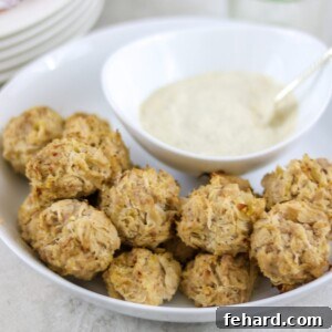 Baked sauerkraut balls in white dish with mustard sauce to the side