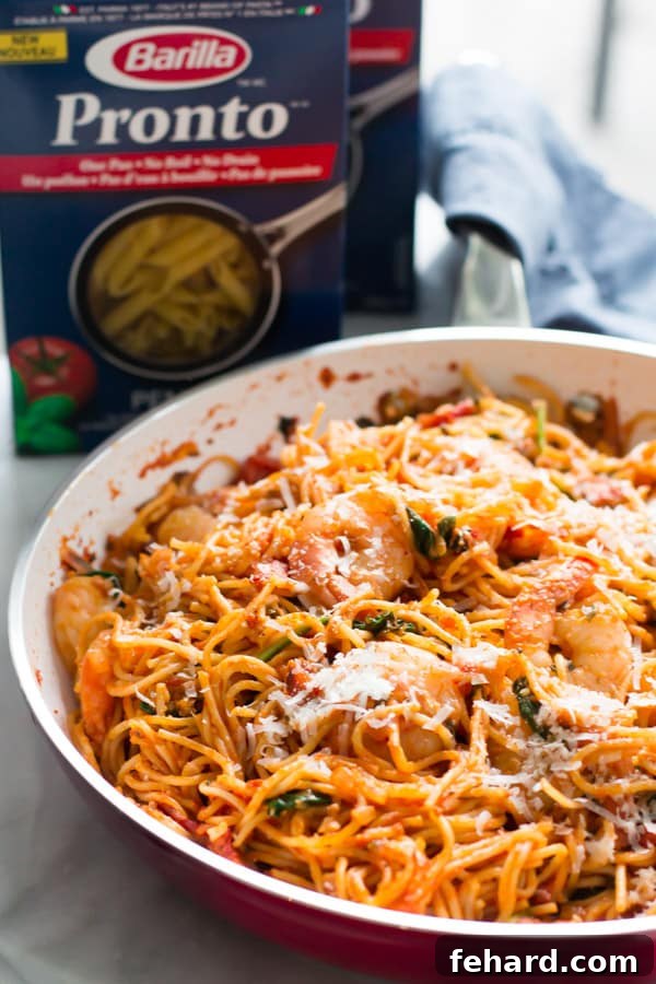 A large skillet filled with One-Pan Shrimp Spaghetti, ready to serve