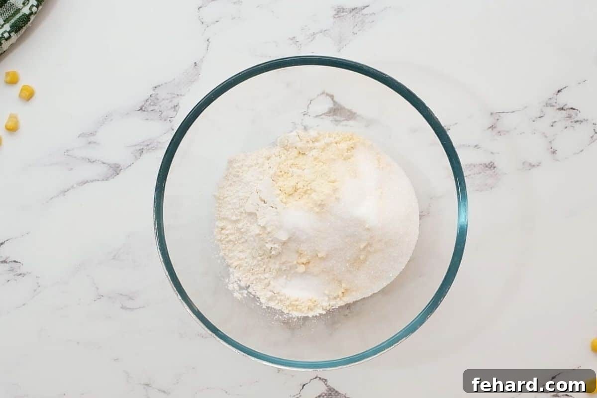 The ingredients for homemade Jiffy corn muffin mix in a mixing bowl.