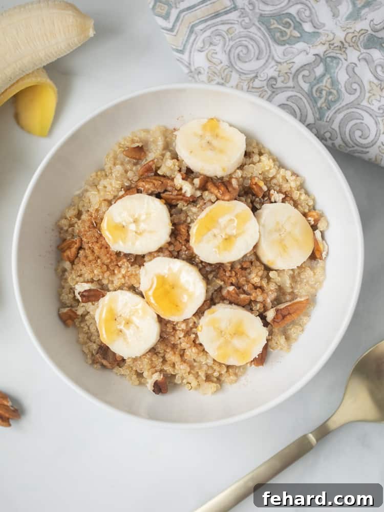 Quinoa Porridge Recipe Quinoa Porridge in white bowl with sliced bananas and pecans.