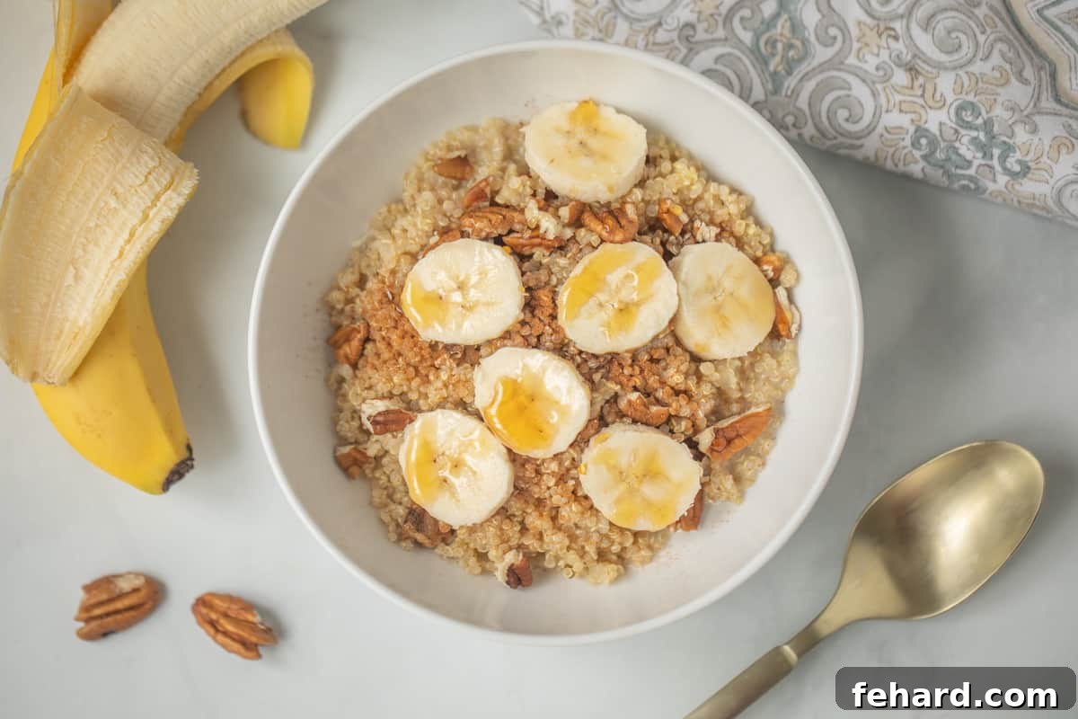 Breakfast Porridge Quinoa Porridge in white bowl with sliced bananas and pecans.