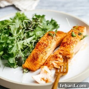 Closeup of white plate containing air fryer salmon
