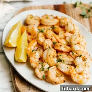 overhead view of a white plate containing cooked shrimp