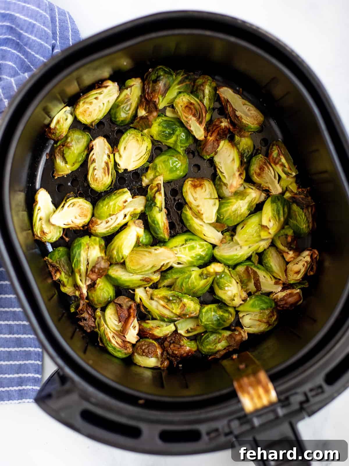 Brussels Sprouts in Air Fryer Basket. 
