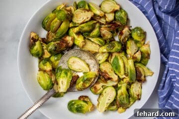 White bowl with crispy air fried Brussels Sprouts.
