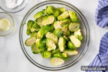Air Fryer in Brussels Sprouts seasoned with salt and pepper.