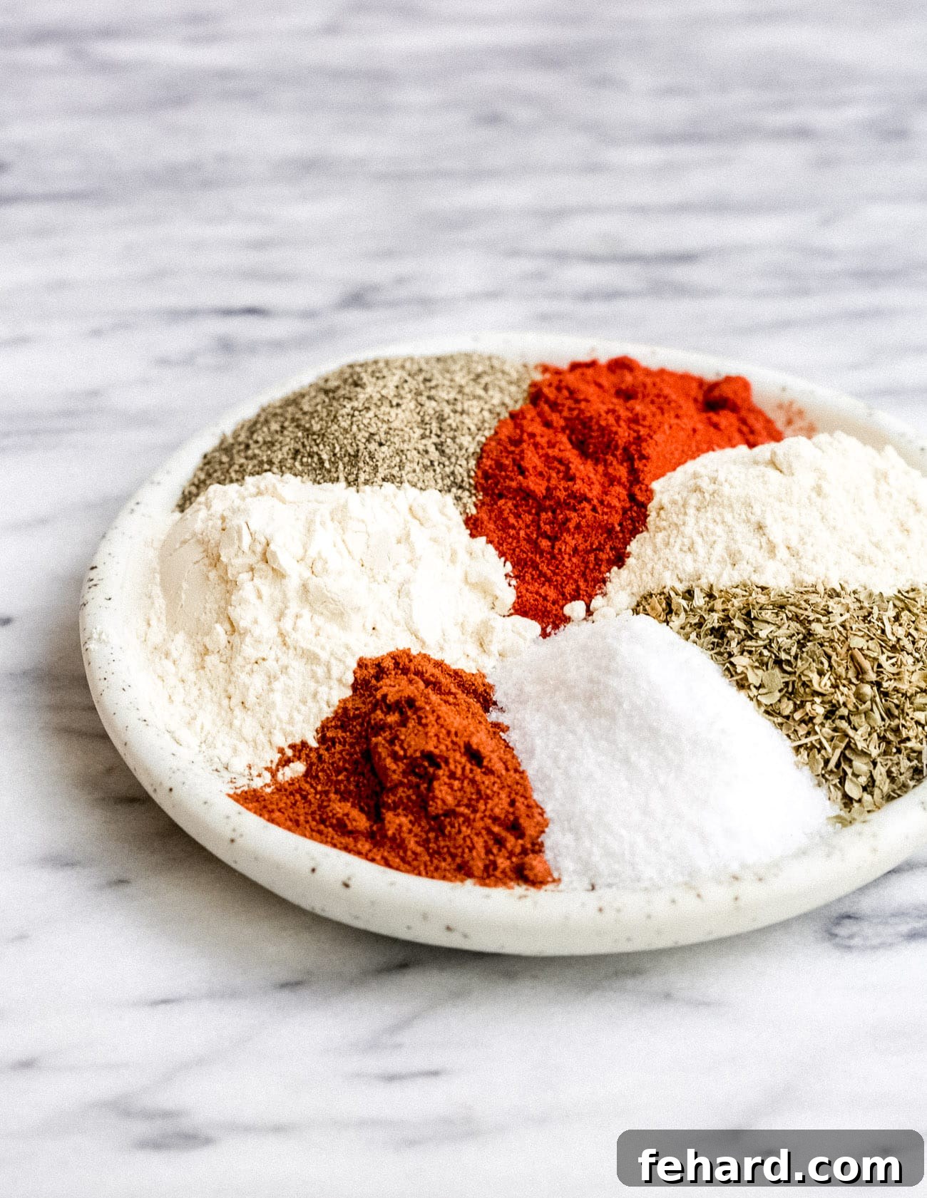 A close-up shot of homemade Cajun seasoning in a small bowl, ready to be incorporated into various dishes.