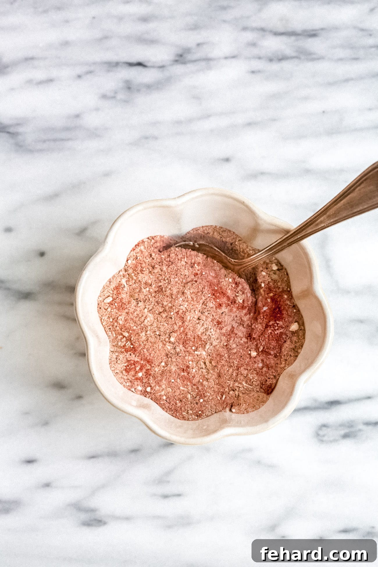 A bowl filled with freshly prepared homemade Cajun seasoning, perfectly blended and ready for use.