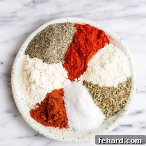 Cajun spices mixed on a small plate, ready for seasoning.