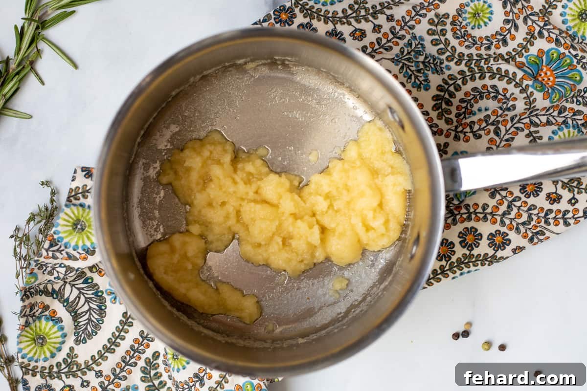 Stress-Free Turkey Gravy 2 Golden roux made from butter and flour in a saucepan, whisked to a thick, smooth paste, forming the base of the gravy.