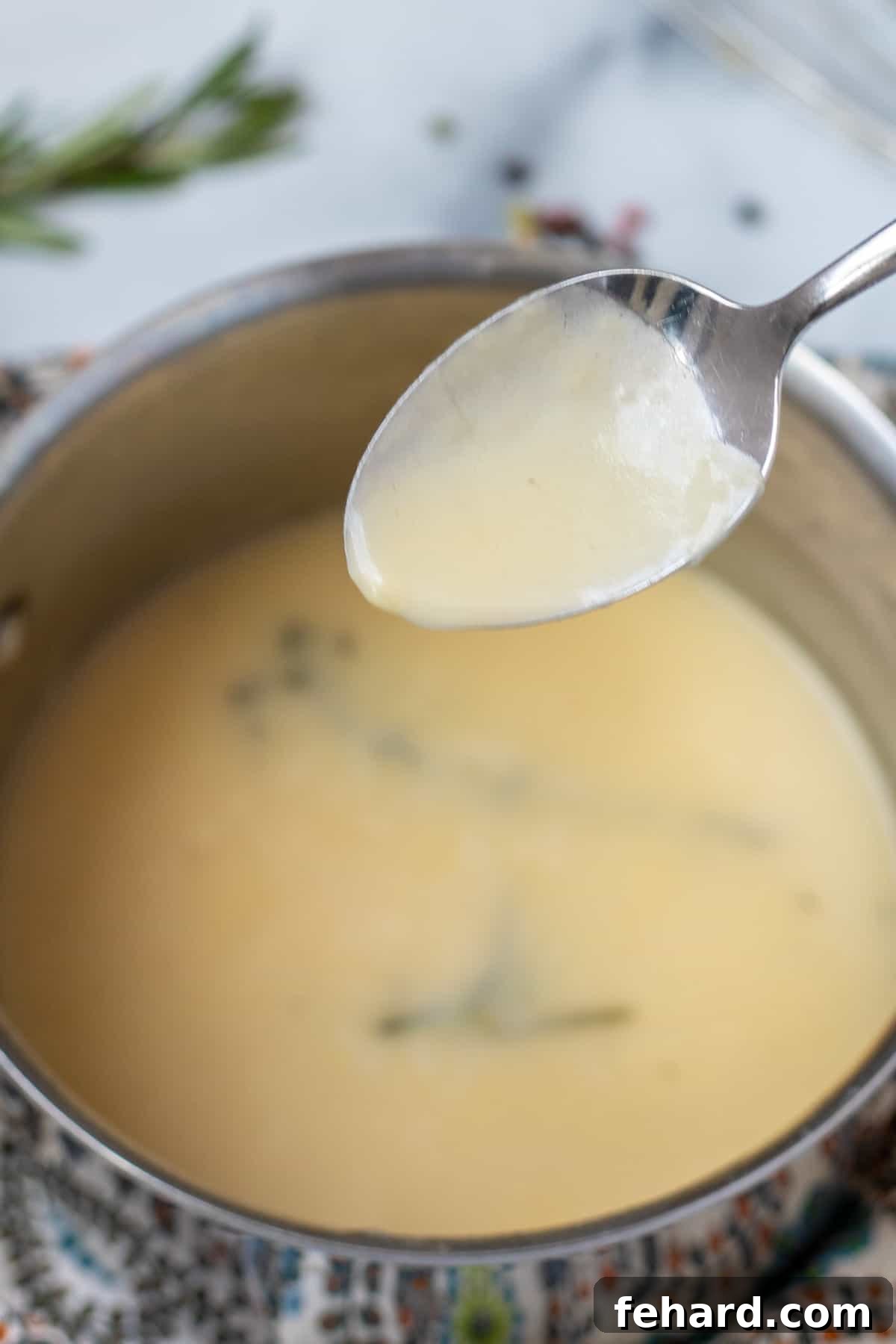 Stress-Free Turkey Gravy 4 Homemade turkey gravy demonstrating perfect thickness, clinging generously to the back of a silver spoon.