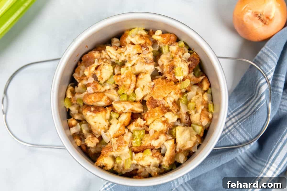 Moist, cooked bread stuffing in a 7-inch cake pan, freshly removed from the Instant Pot after pressure cooking.
