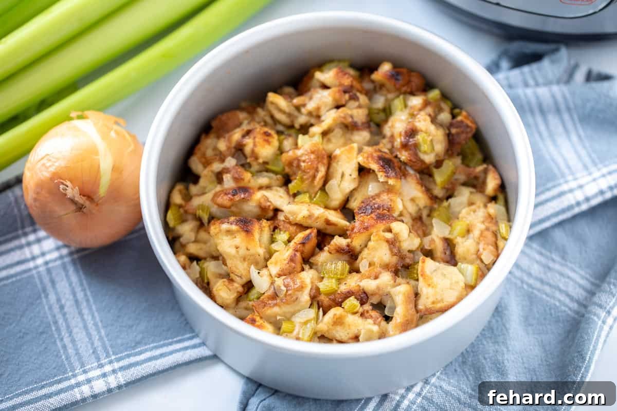 Beautifully browned and crispy Instant Pot Stuffing in a cake pan, garnished with fresh celery, next to the Instant Pot.