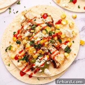 Grilled Chicken Fajita topped with corn salsa and hot sauce.