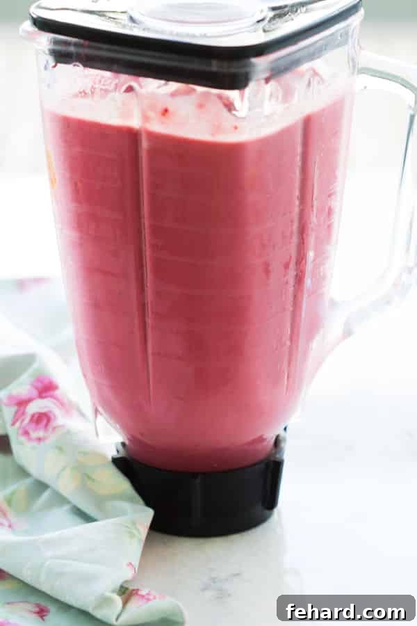 Close-up view of Healthy Blender Raspberry Ice Cream in a glass, highlighting its smooth and rich consistency, ready to be enjoyed.