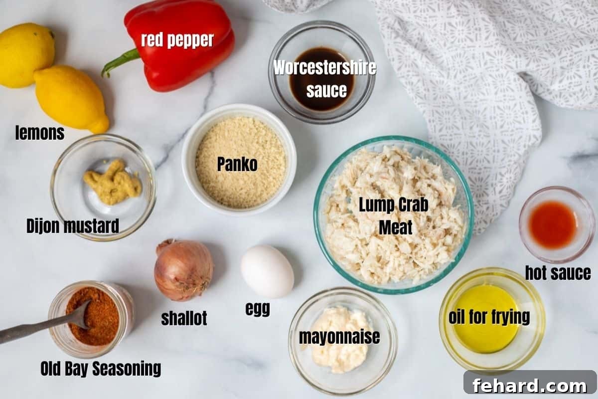 Arrangement of fresh ingredients for crab cakes on a kitchen counter: lump crab meat, shallots, red bell pepper, lemon, mayonnaise, Old Bay seasoning, and Panko breadcrumbs.