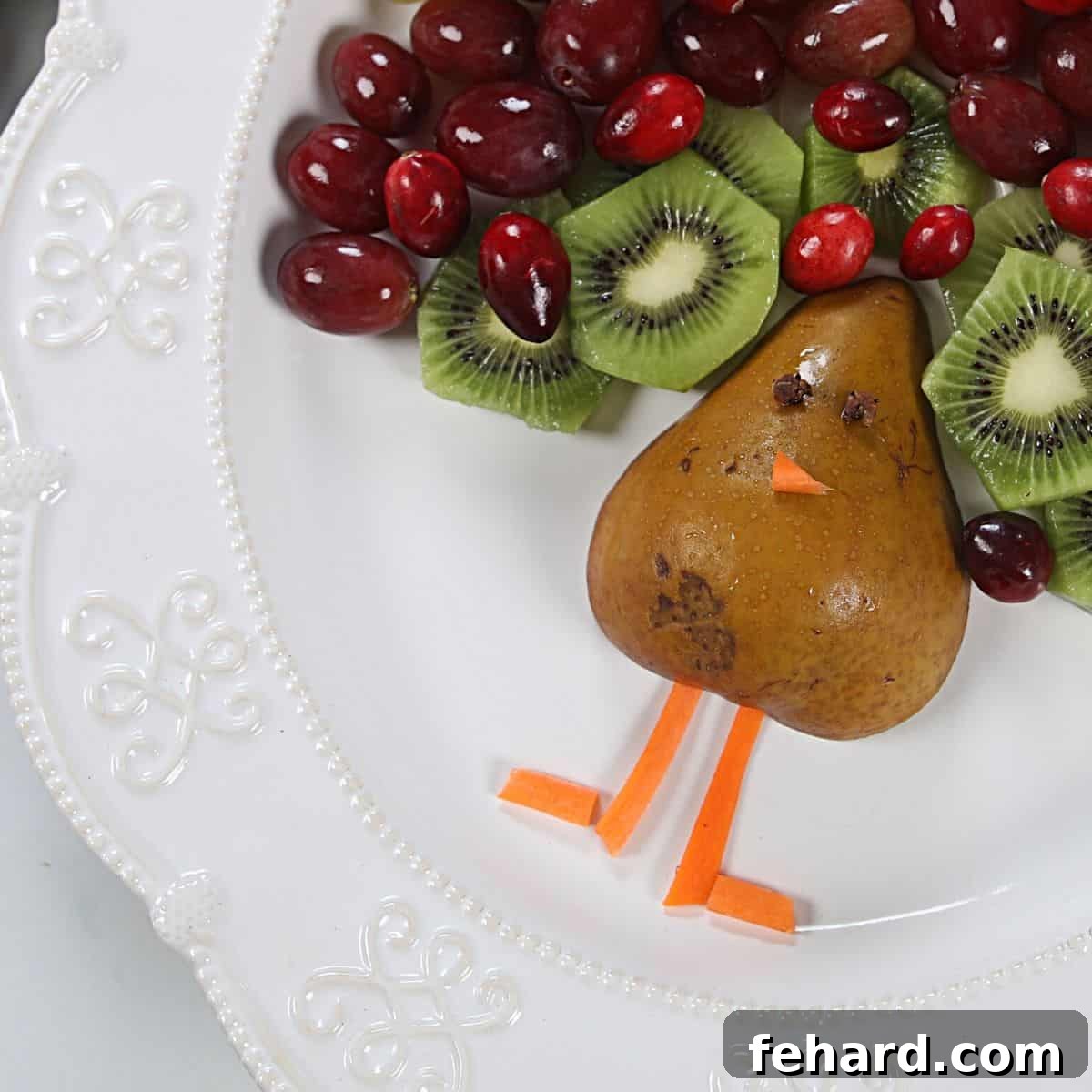 A close-up view of the fruit turkey body, showing the pear, carrot legs and beak, and clove eyes.
