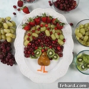 Fruit arranged to look like feathers of a turkey on a white platter.