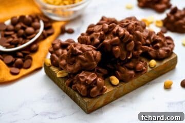 Set-It-and-Forget-It Sweets 8 Crockpot candy on wooden cutting board made with salted peanuts and covered in chocolate mixture.