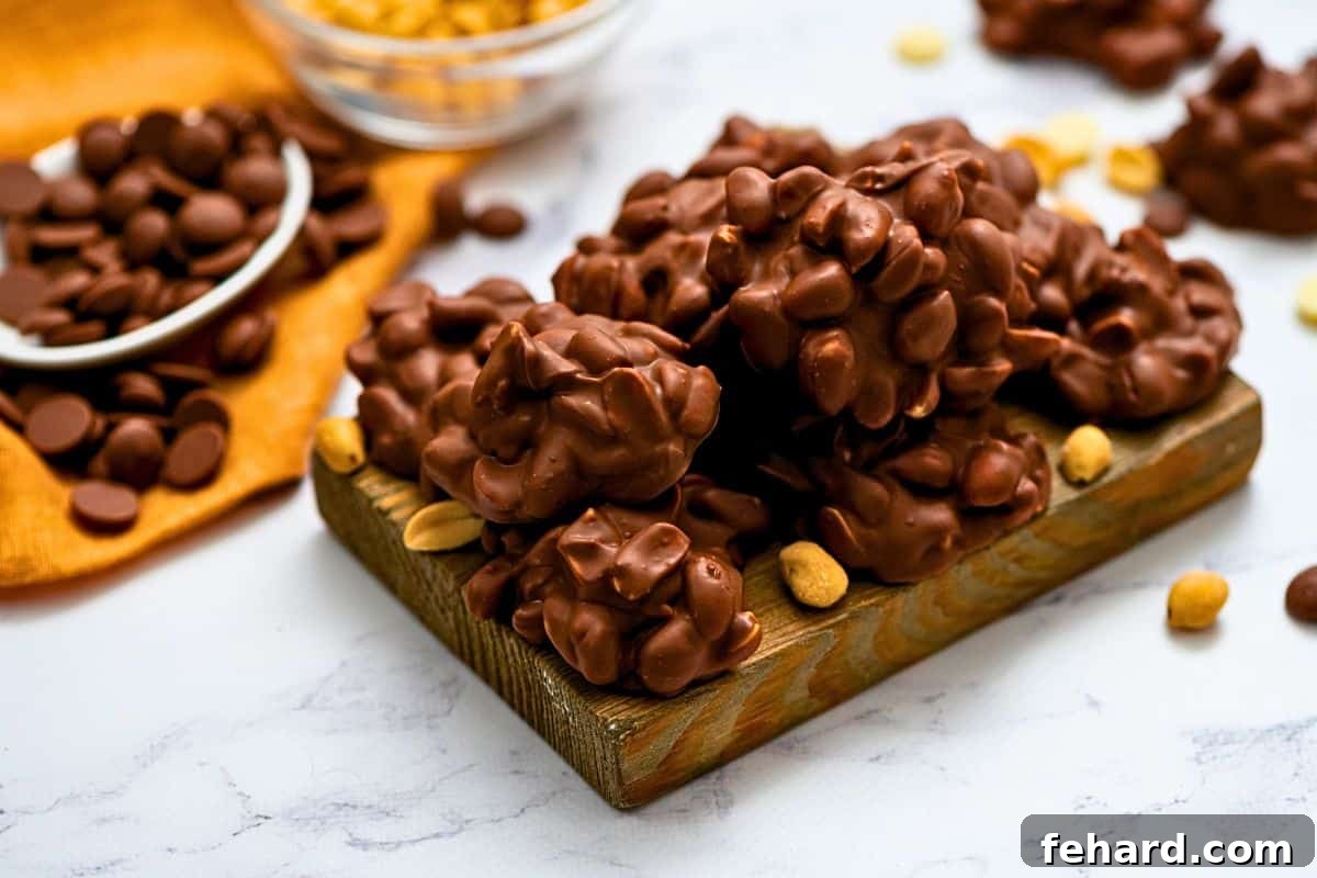Perfectly Hardened Nut Clusters Recipe Finished Crockpot candy, made with salted peanuts and covered in a rich chocolate mixture, perfectly hardened and arranged on a rustic wooden cutting board.