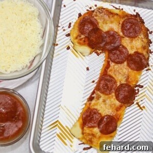 Candy Cane Shaped Pepperoni Pizza on baking sheet.