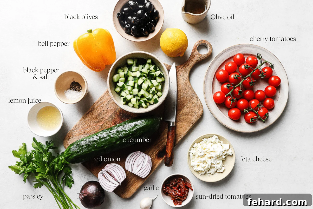 overhead view of individual Mediterranean Salad ingredients neatly arranged on a white surface
