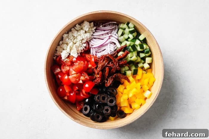 freshly chopped ingredients for Mediterranean Salad in a large bowl