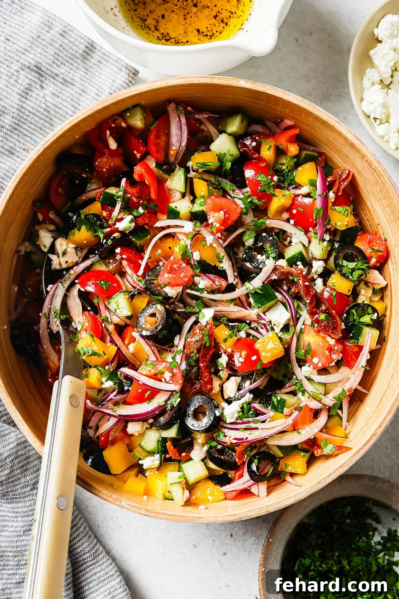 overhead view of a vibrant Mediterranean Salad in a white bowl, freshly dressed and ready to eat