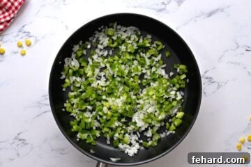 Sauteed onions and peppers in a skillet.