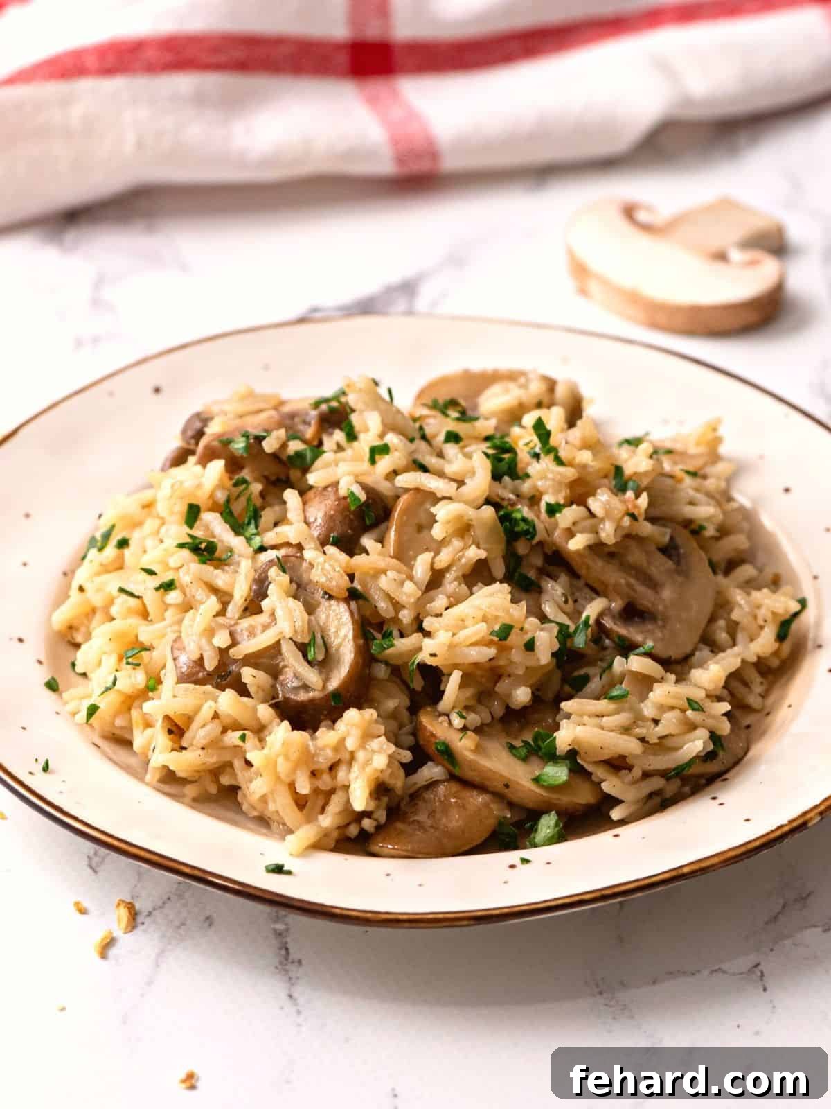 Flavorful Homemade Rice Pilaf with Mushrooms A beautifully presented bowl of homemade Mushroom Rice Pilaf, garnished with fresh green parsley, ready to be served as a gourmet side dish.