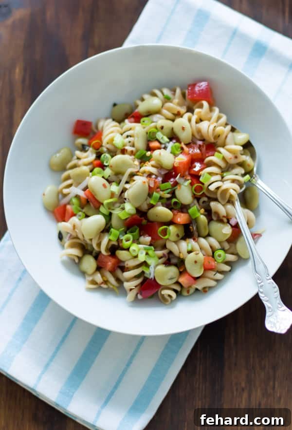 bowl of pasta salad with lima beans, anchovies, red pepper, red peppers, red onions, scallions, with thyme
