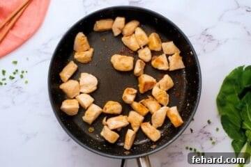 Browned chicken in saute pan to start chicken and bok choy stir fry.