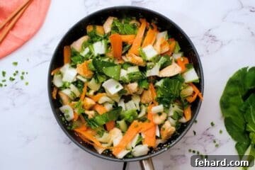 Chopped bok choy, carrot ribbons, and green onions added to browned chicken for quick and easy stir fry recipe.
