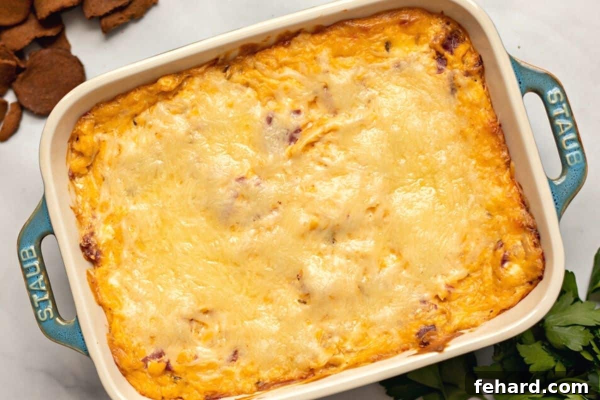 Baked Reuben Dip in casserole dish next to fresh parsley.