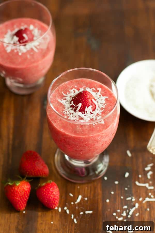 Strawberry Coconut Chia Pudding in a clear jar, beautifully layered with fresh strawberries, ready for a healthy and easy breakfast.
