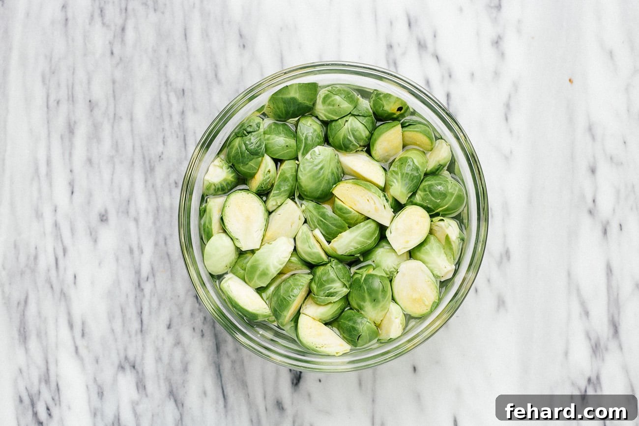 Brussels sprouts soaking in a bowl of water.