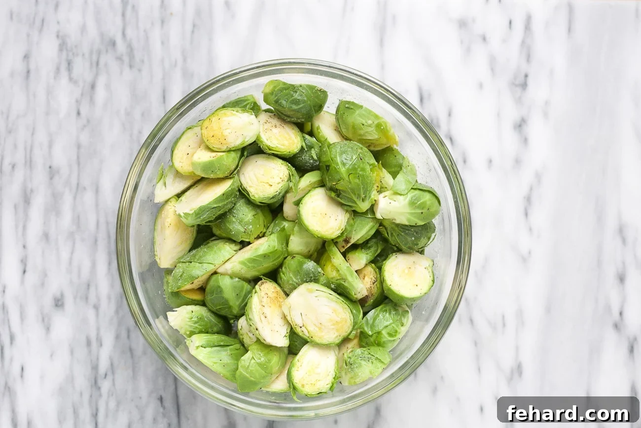 Seasoned Brussels sprouts in a glass bowl. 
