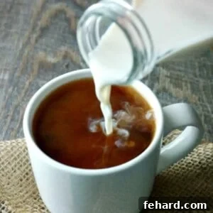 Homemade Coffee Creamer being poured into a white coffee mug.
