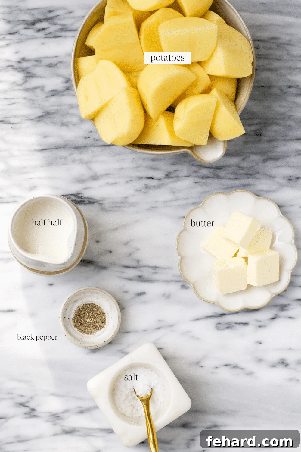 Ingredients for instant pot mashed potatoes including potatoes, butter, heavy cream, salt, pepper, and fresh parsley.
