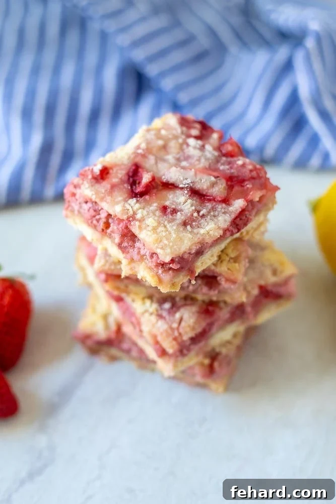 Strawberry Crumb Bars Four perfectly baked and stacked Strawberry Crumb Bars with a visible buttery crust, creamy filling, and golden streusel.