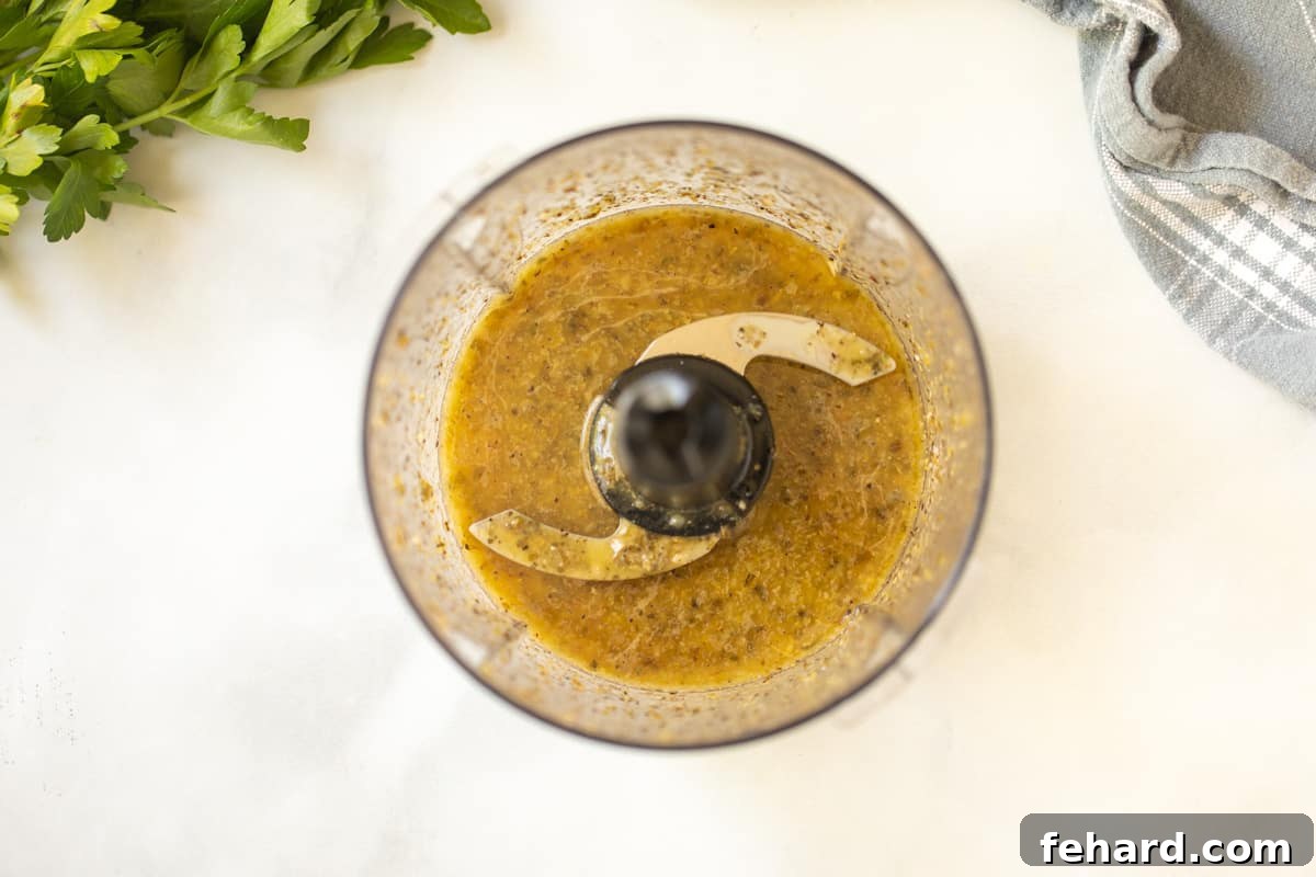Quinoa Salad with Greek Dressing Homemade Greek Dressing being blended in a mini food processor for perfect smoothness.